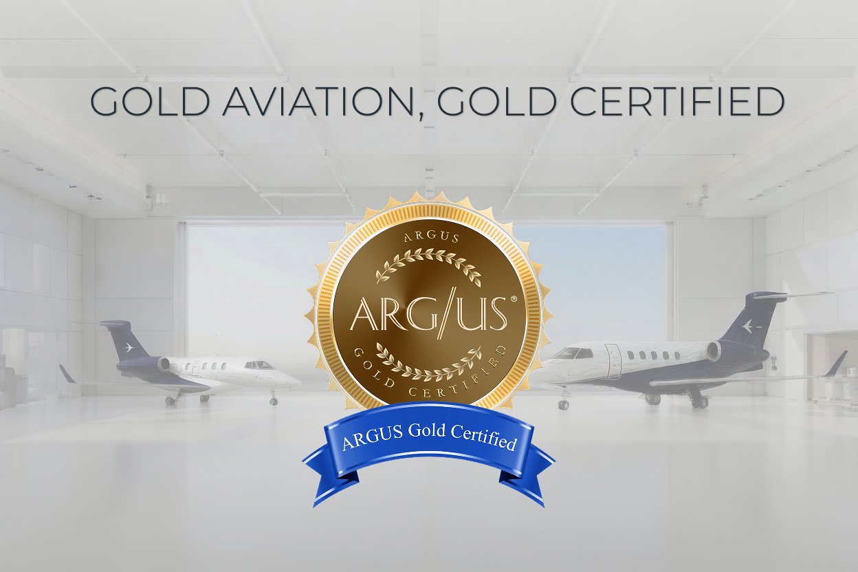 Gold Aviation, Gold Certified — ARGUS Gold Certified medallion in Gold Aviation's hangar with two Embraer jets